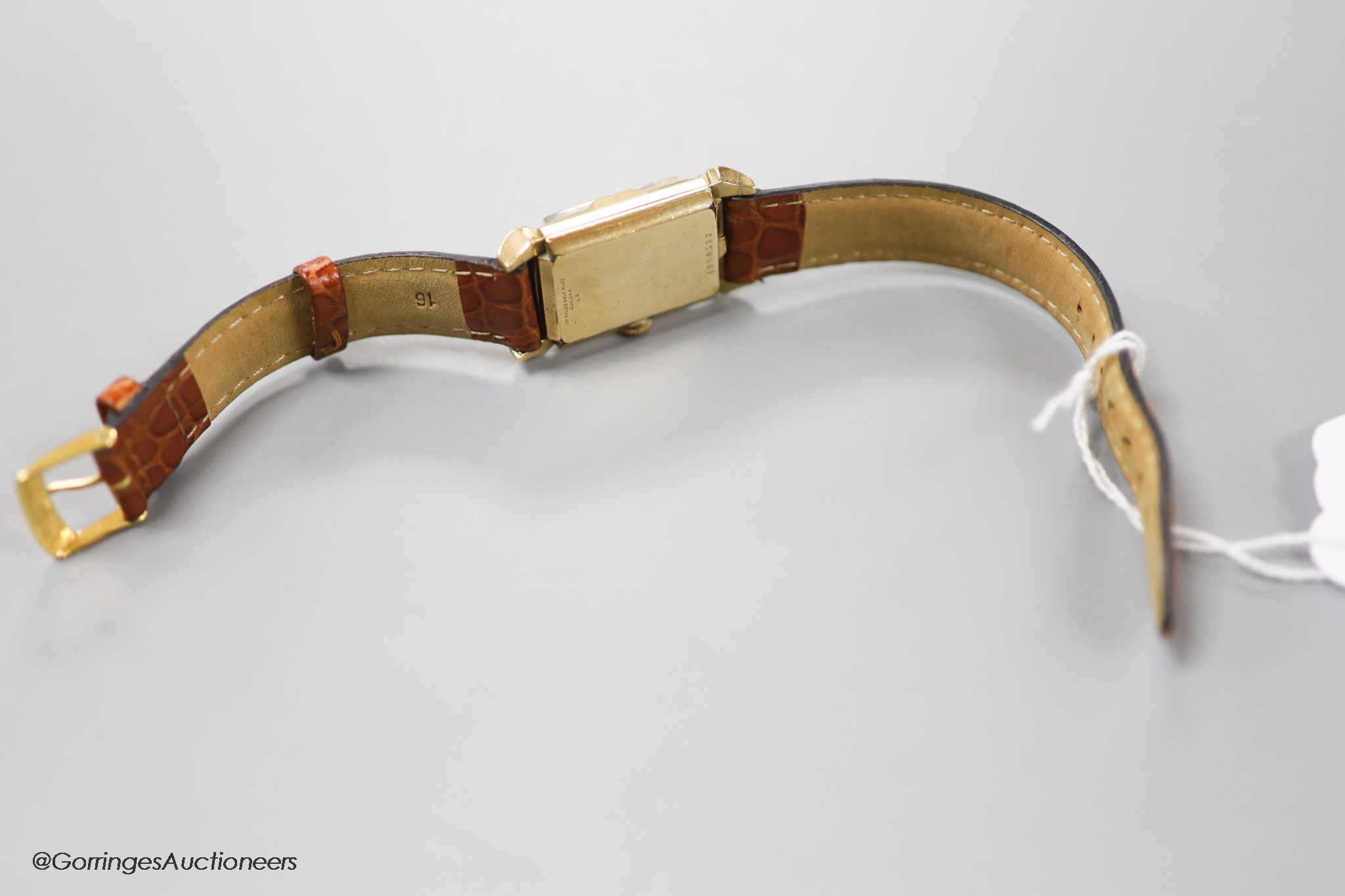 A gentleman's 1930's 10k rolled gold Bulova manual wind rectangular dial wrist watch, with subsidiary seconds, on later leather strap.